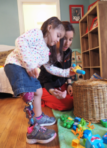 Child putting toys away